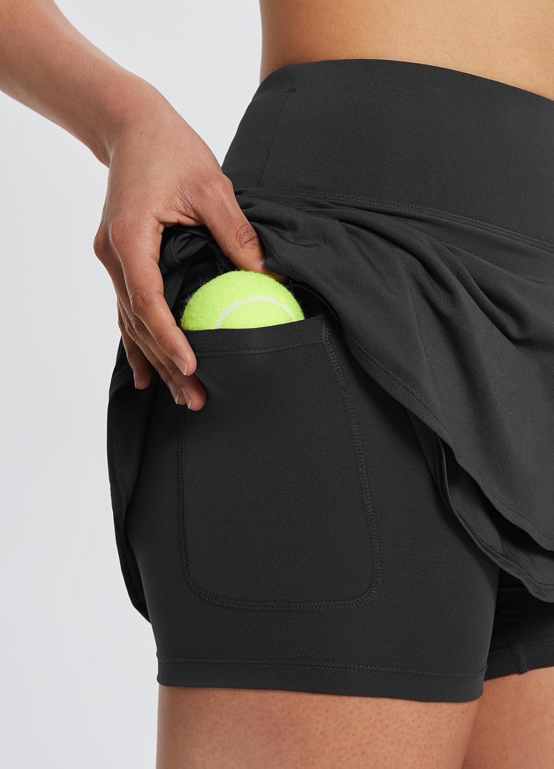 BALEAF tennis skirt worn on model showing the high-rise waistband fit and mini-length silhouette for tennis and pickleball