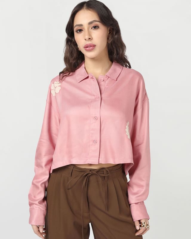 Bewakoof Onion Pink crop shirt styled with high-rise brown wide-leg trousers, showing the cropped hem and boxy oversized drape