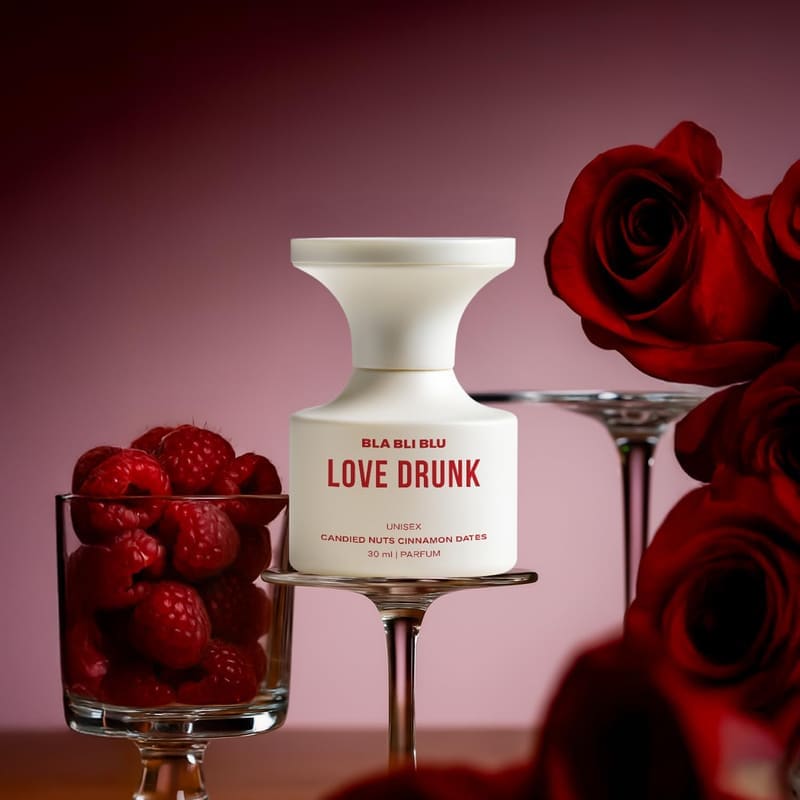 BLABLIBLU Love Drunk bottle beside a glass of raspberries and red roses