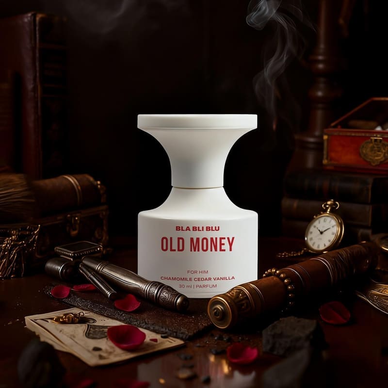 BLABLIBLU Old Money white bottle styled on a wooden desk with a pocket watch and vintage props