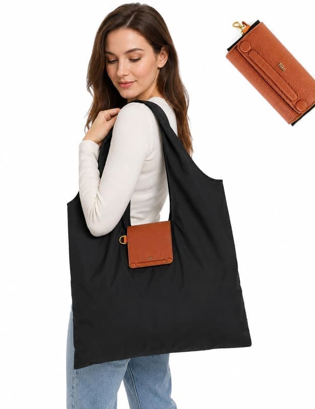 HIE Lepayt tote bag folded flat in its travel form, showing how the soft body compresses down to a small clutch-sized rectangle for packing inside a suitcase or larger handbag