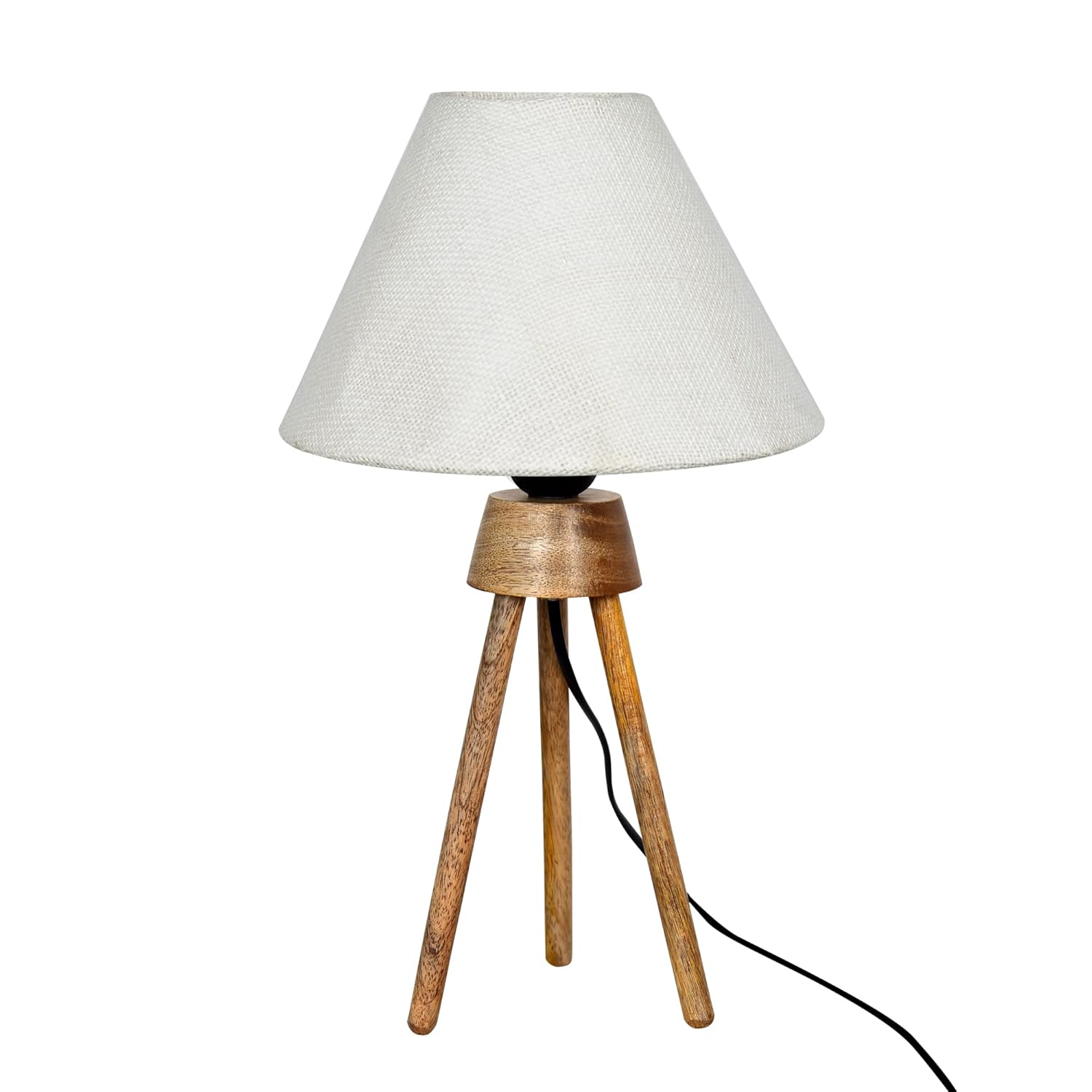 Homesake tripod table lamp lifestyle shot on a wooden nightstand next to a bed, illuminated with a warm-white E27 LED showing the soft ambient glow through the linen fabric shade and the rustic farmhouse aesthetic