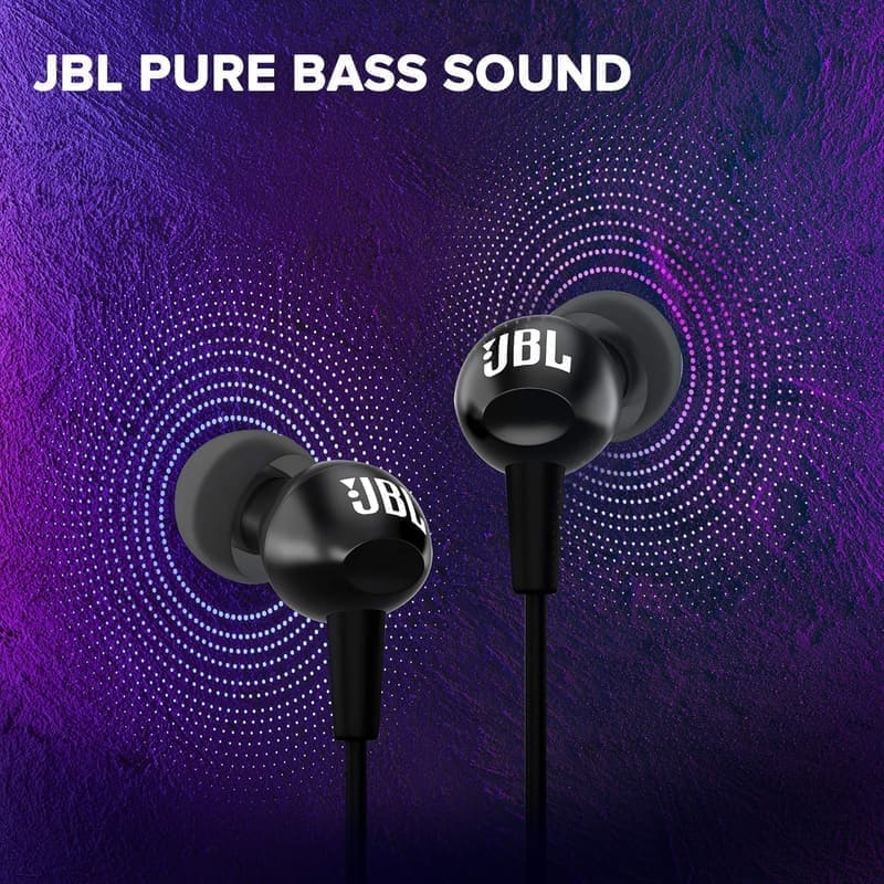 JBL C100SI angled ear-tip detail shot showing the forward-canting silicone tip geometry, the metallic JBL logo housing and how the angled fit sits in the canal versus a straight-fire alternative