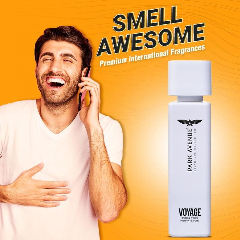 Smiling man on a phone call next to a Park Avenue Voyage bottle, captioned Smell Awesome