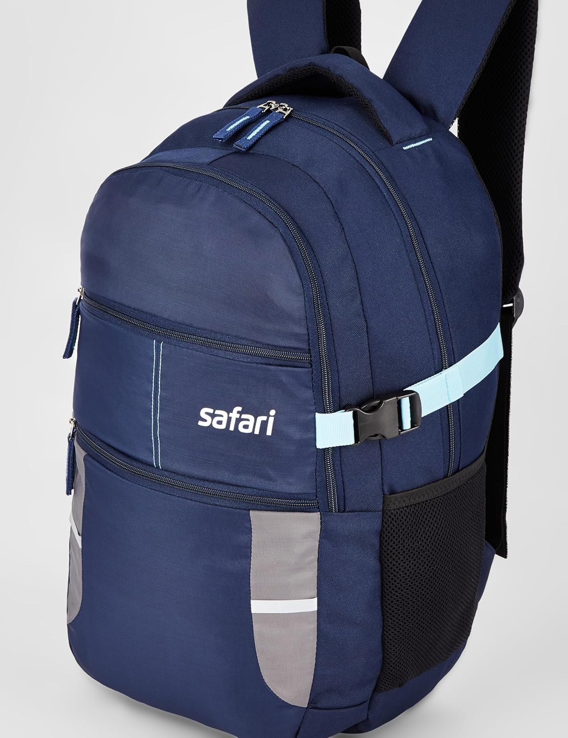 Safari Omega laptop backpack with the integrated raincover deployed over the navy-blue body, demonstrating the monsoon-protection feature stowed at the base of the bag