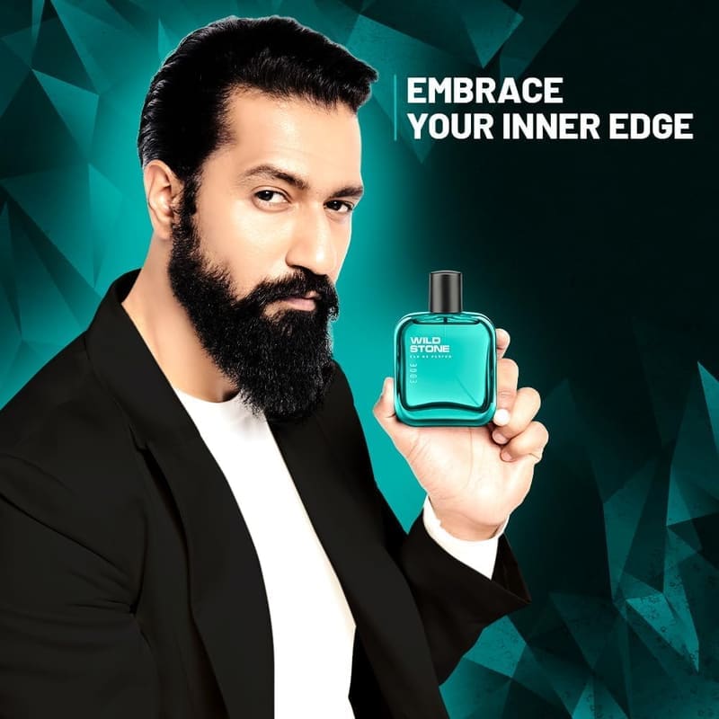 Bearded man in a black blazer holding the teal Wild Stone Edge bottle with the tagline Embrace Your Inner Edge